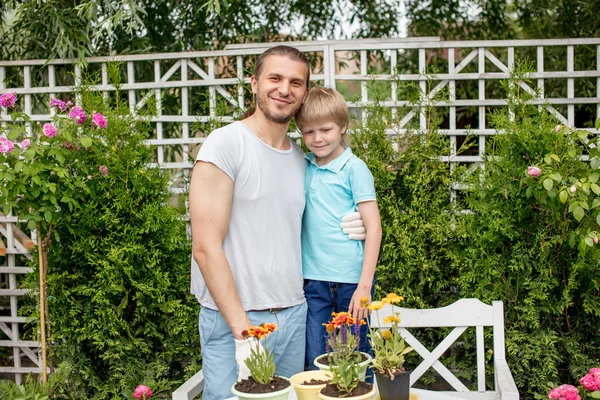 Portrait of happy father and son standing in yard