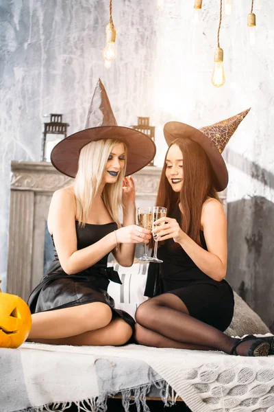 Two Happy Young Women Black Witch Halloween Costumes Party Sitting — Stock Photo, Image