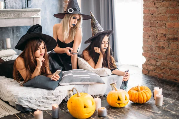 witches use the phone and tire at the Halloween party