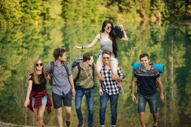 cheerful travelers are listening to the music while going hiking clipart