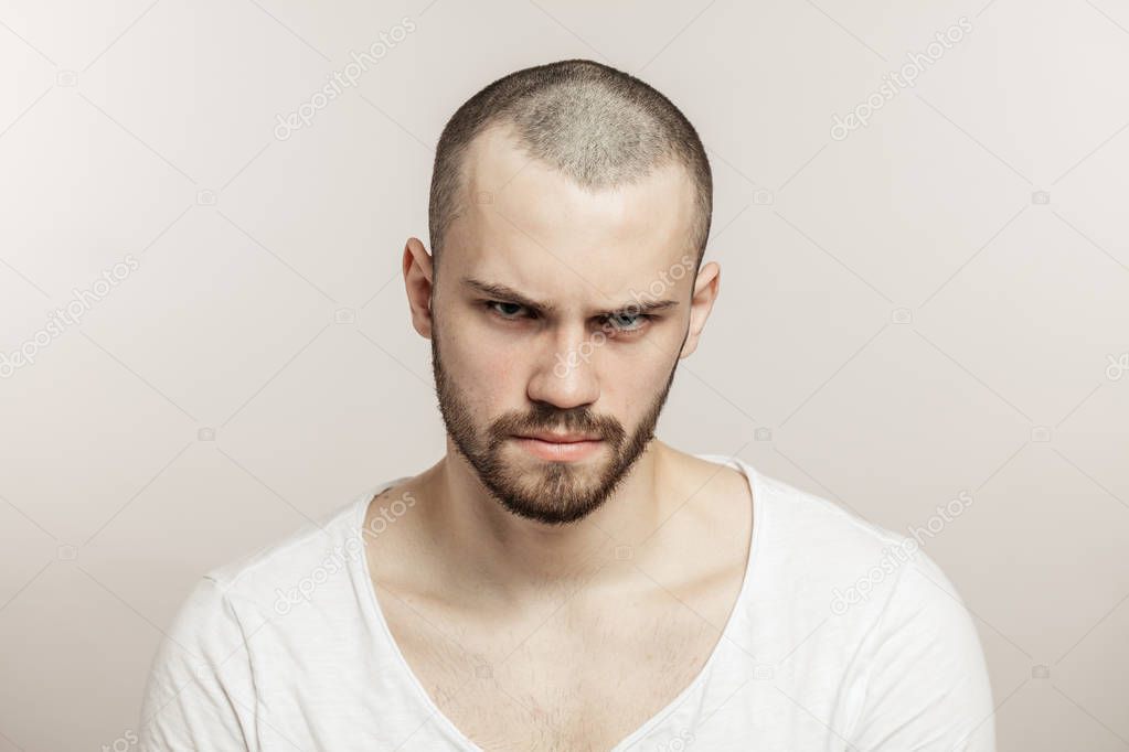 Nervous, doubtful, unhappy, frustrated man frowning his eyebrow