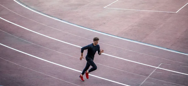 Vista superior Atleta corriendo en pista de atletismo. Corredor corriendo en pista roja en el estadio —  Fotos de Stock