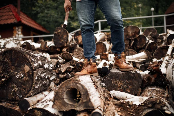 Bearded mohawk Man choise firewoods for fireplace — Stock Photo, Image