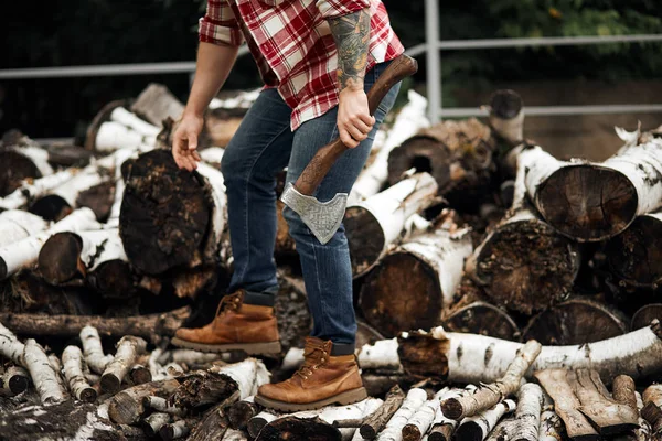 Bearded mohawk Man choise firewoods for fireplace — Stock Photo, Image