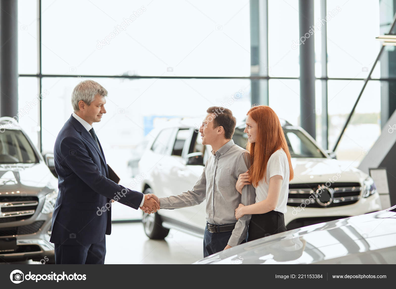 Car sales manager telling about the features of the car to the