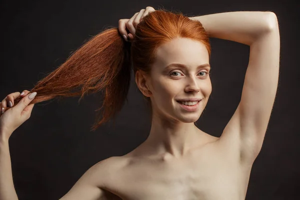 Slim young sex appealing girl with long gorgeous red hair on black background — Stock Photo, Image