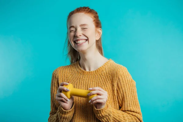 Feliz bonito redhaired jovem mulher posando com amarelo halteres — Fotografia de Stock