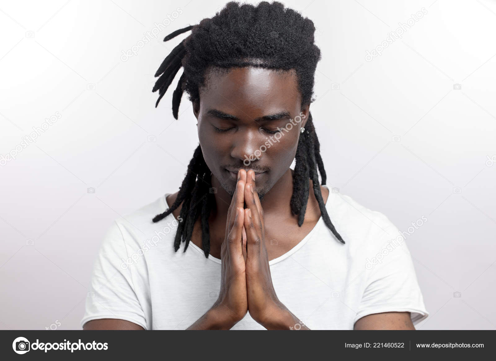 Close Up Of Black Man With Dreadlocks Praying On White