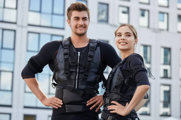 two pleasant people are happy because they have tested new EMS suits for the first time
