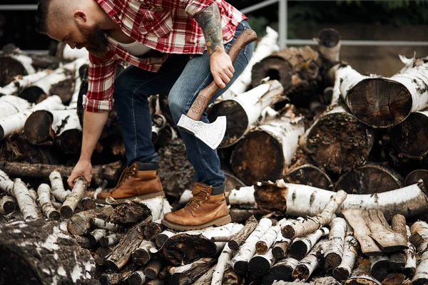 Bearded mohawk Man choise firewoods for fireplace — Stock Photo, Image