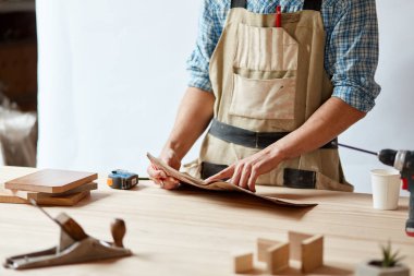 portre görünümünde bir plan üzerinde bir çizgi çizmek için kırmızı bir kalem kullanarak bir marangoz