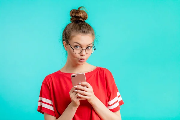 Impresionante chica usando un moño usando su gadget y posando a la cámara — Foto de Stock