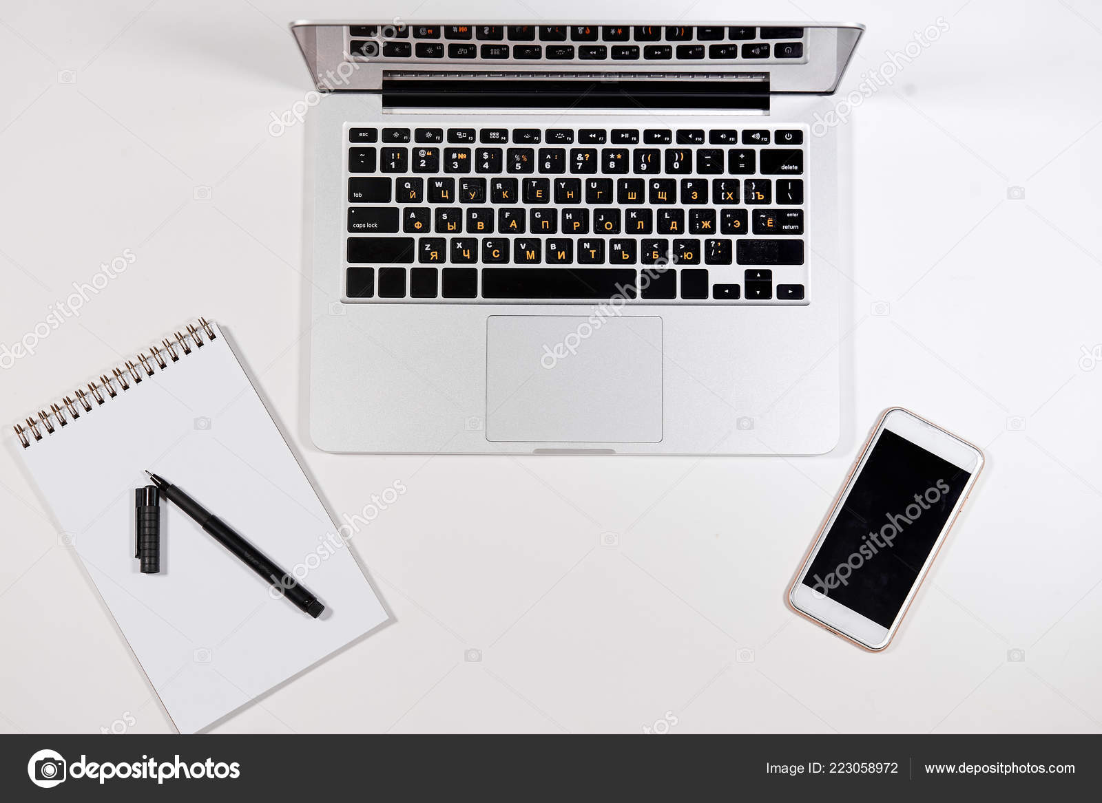 White Office Desk With Many Things On It Stock Photo