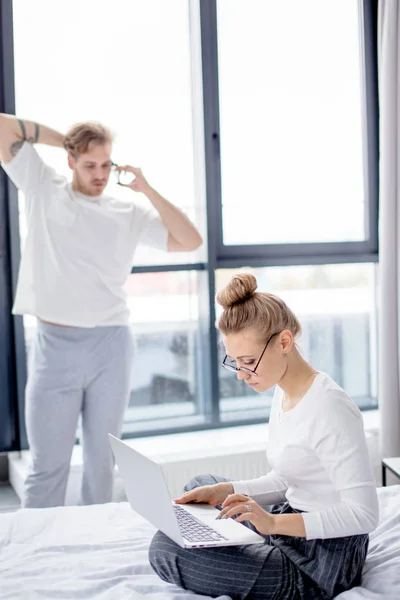 Jonge ambitioous s vrouw met hairbun met behulp van haar laptop — Stockfoto