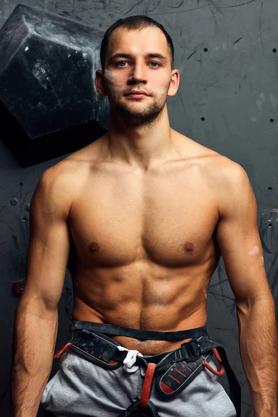 Closeup portrait of rock climber against artificial wall for climbing