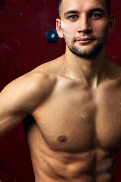 Closeup portrait of rock climber against artificial wall for climbing