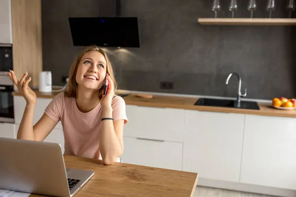 Joyful positive girl sharing with happy news with a best friend on the phone — Stock Photo, Image