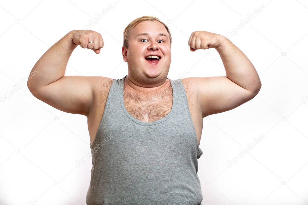 Funny overweight sports man flexing his muscle isolated on white background
