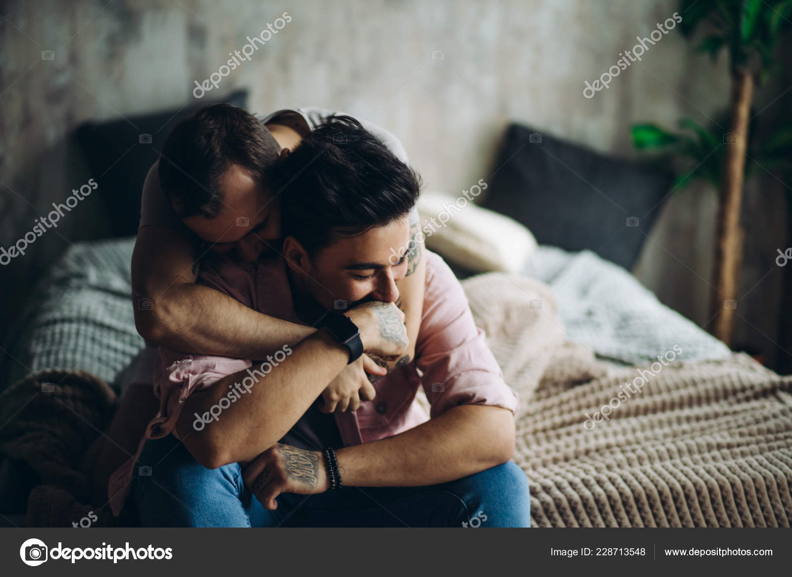 Foto de Two sexy blue guys enjoying being together, hugging each other  tenderly lying on bed in underwear. Men having happy and cheerful  expression. Alternative same-sex Love and Tenderness Concept do Stock