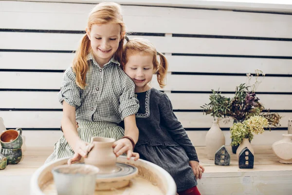 Positive ginger children working with clay in the studio — Stock Photo, Image