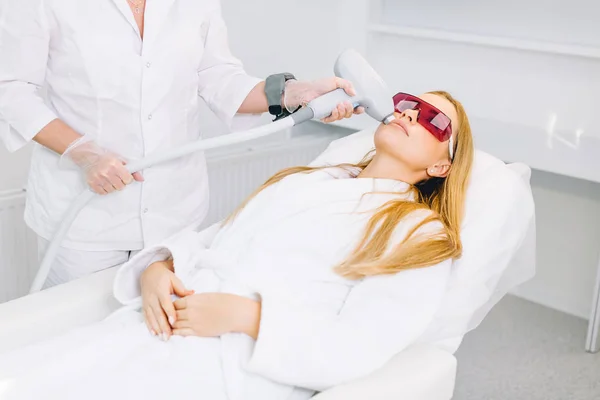 Woman getting laser and ultrasound face treatment in medical spa center — Stock Photo, Image
