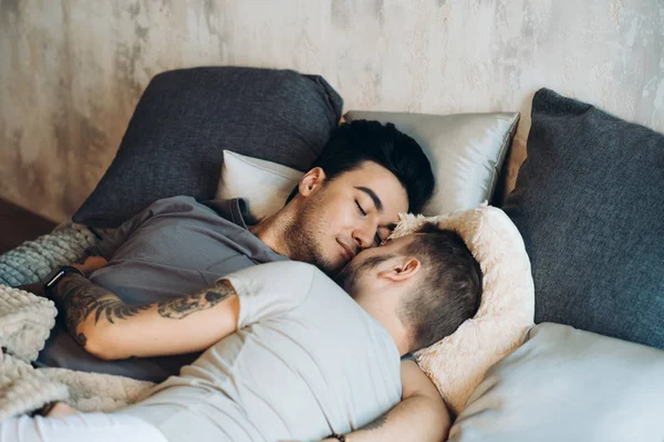 Una pareja homosexual en la cama en el estudio con loft interior —  Fotos de Stock