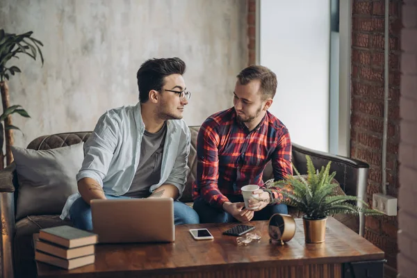 Europees gay man paar besteden tijd samen drinken koffie en kijken laptop — Stockfoto