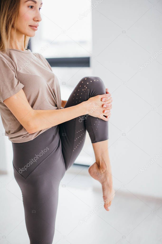 woman standing on one leg with bent leg