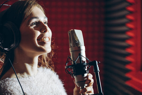 awesome girl enjoying singing the song in the studio