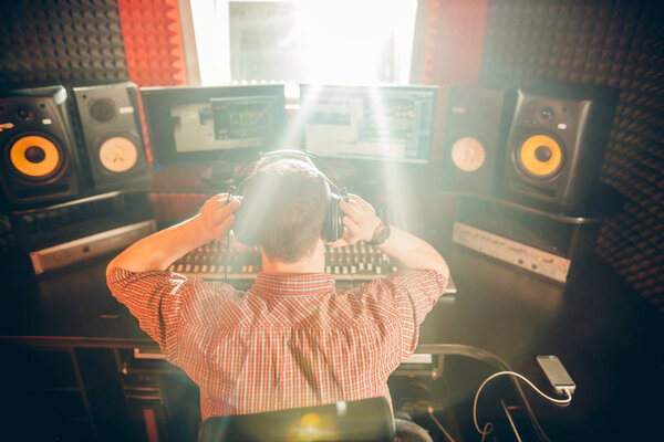 man listening to music while sitting in the studio