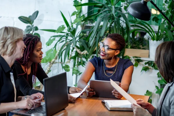 African female manager consulting women at her office promising benefits