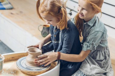ablası küçük kız kardeşi çalışmaları sırasında kil sınıflar denetleme