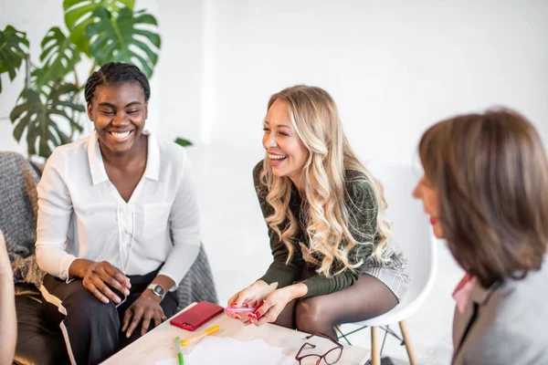 Mulheres africanas e caucasianas se reúnem em estúdio, após sessão de treinamento de sofá — Fotografia de Stock