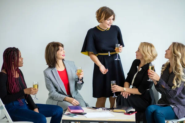 females coworkers celebrating successful start-up of a new project