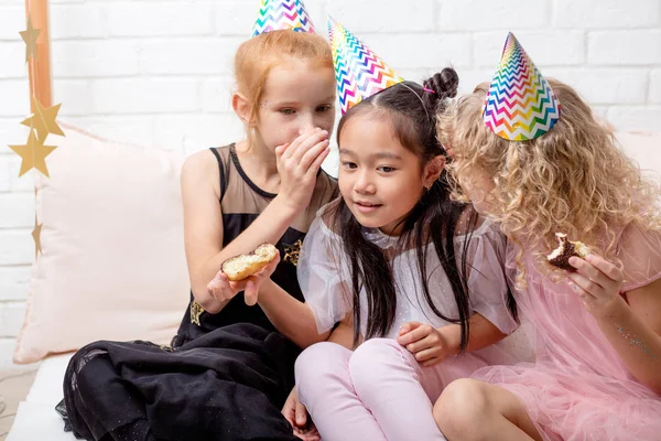 Adorable little girls sharing secrets with each other