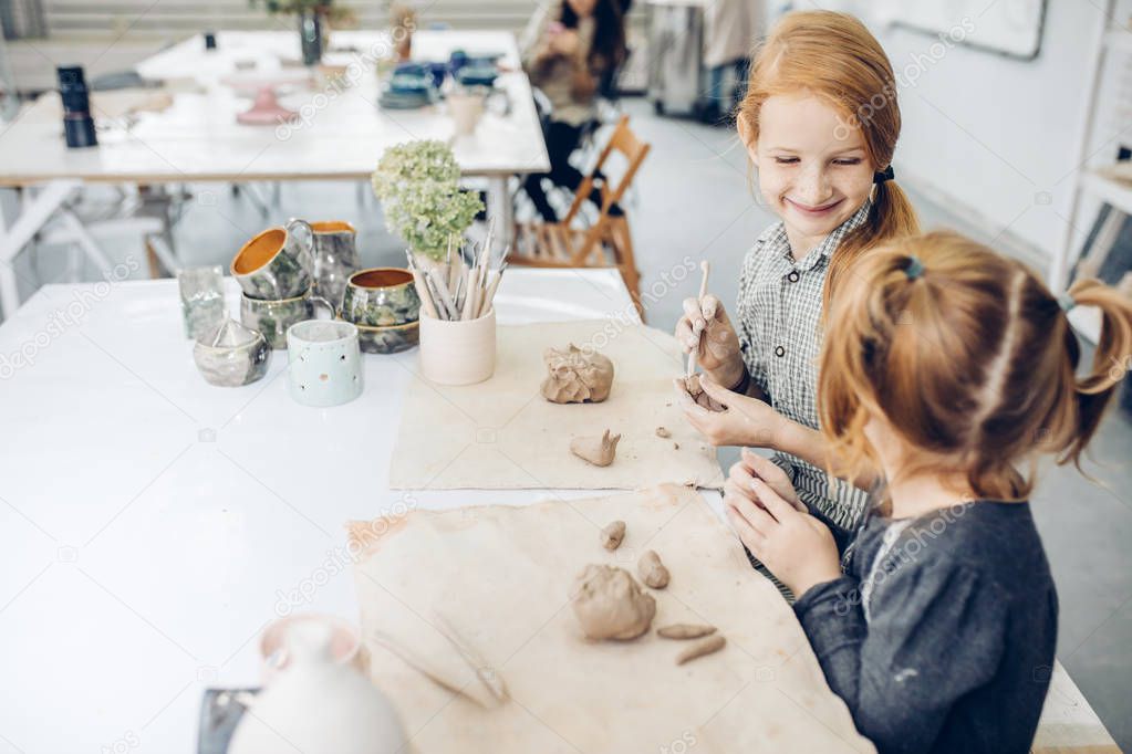 close up photo happy children having fun in the clay studio