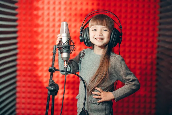 Positive kid posing to the canera during singing classes — Stock Photo, Image