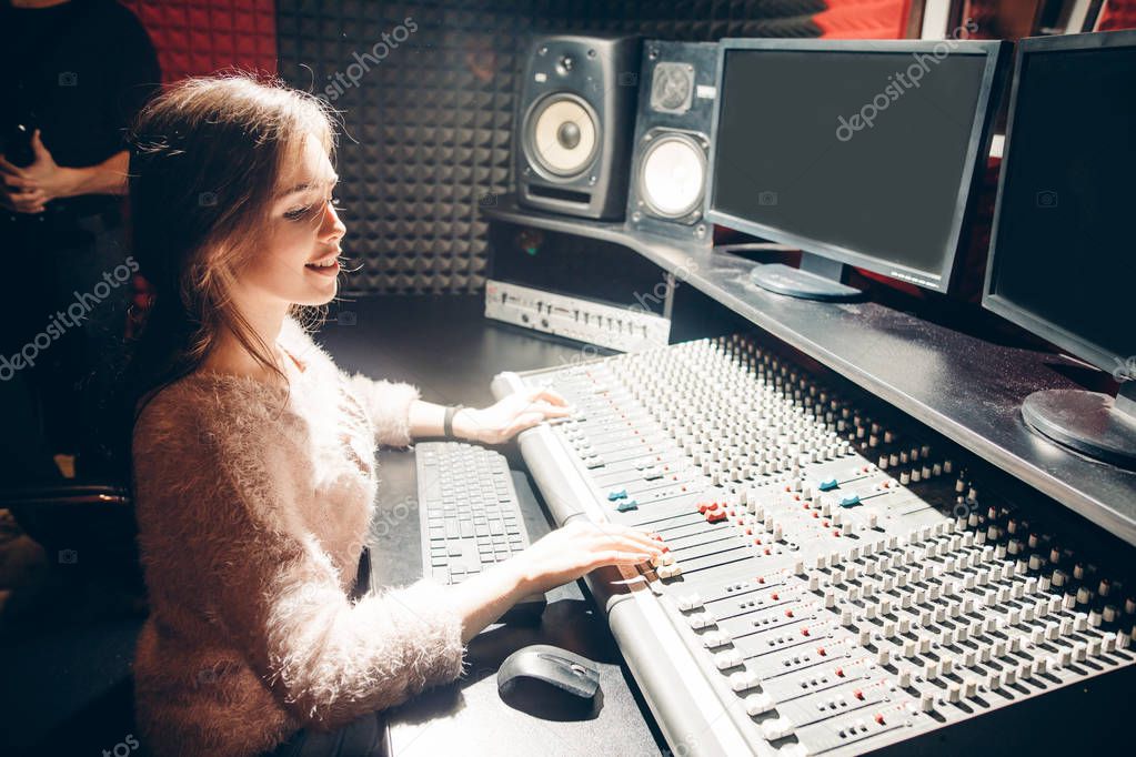young woman learning to work with music device