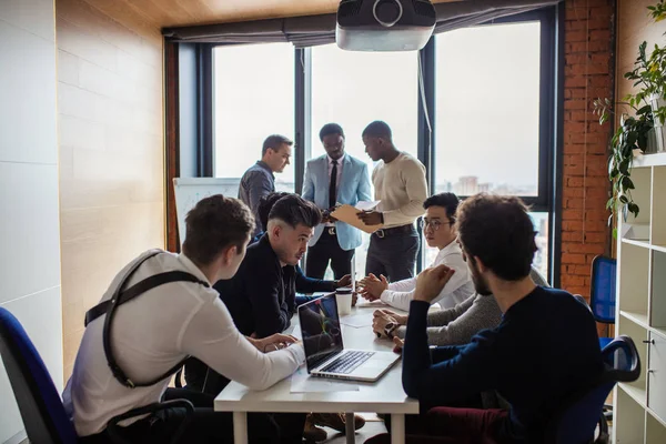 Multiracial male team talking over new project in office meeting room — Stock Photo, Image