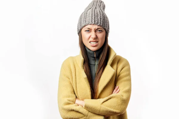 Confused and offended caucasian woman in colorful winter clothes posing indoors — Stock Photo, Image