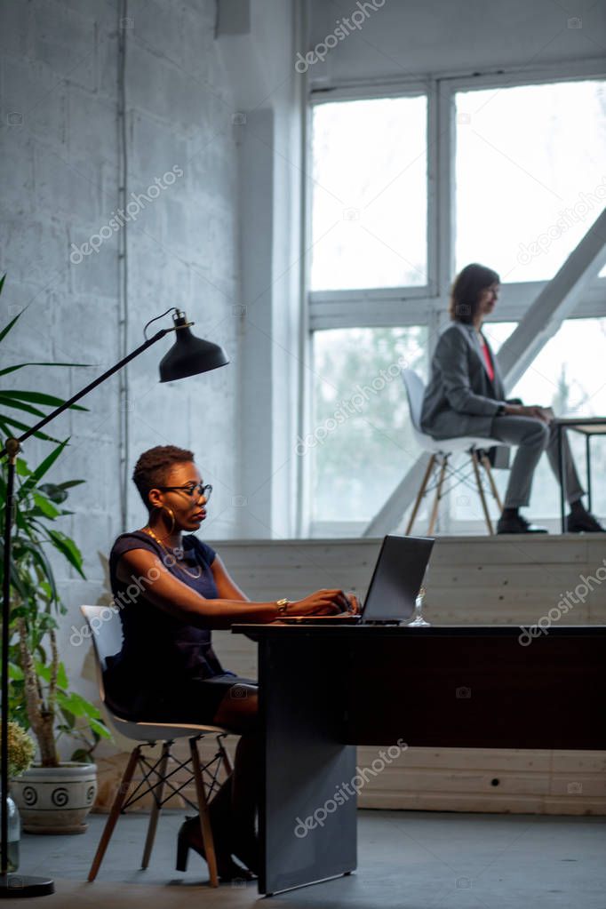 Portrait of African business woman working on laptop in the office
