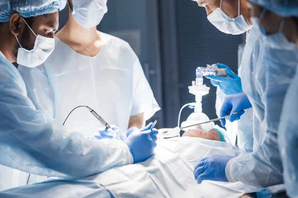 Diverse Team of surgeon, assistants and nurses making invasive surgery — Stock Photo, Image