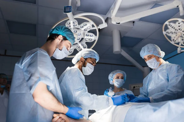 Surgeons perform a complex operation to save a human life at hospital — Stock Photo, Image