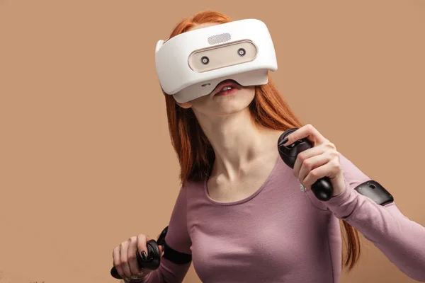 Happy young red-haired woman using a virtual reality headset — Stock Photo, Image