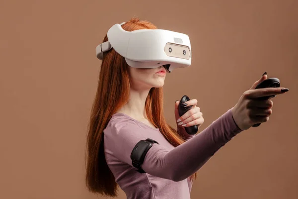 Happy young red-haired woman using a virtual reality headset — Stock Photo, Image