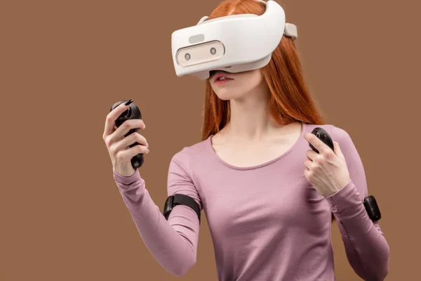 Happy young red-haired woman using a virtual reality headset — Stock Photo, Image