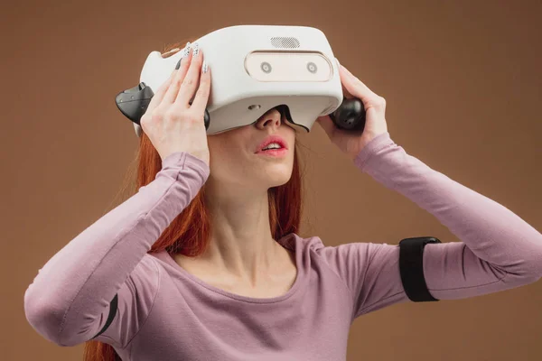 Happy young red-haired woman using a virtual reality headset — Stock Photo, Image