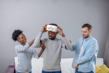 Çok kültürlü arkadaşlar Afrika adam için manade vr kulaklık ile fist saat için yardım