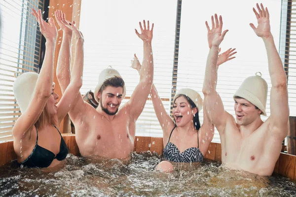 Group of caucasian diverse friends enjoying jacuzzi in hotel spa — Stock Photo, Image
