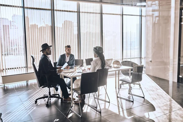 mixed race business people chatting in modern office